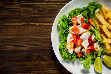 Fried cod and vegetables with french fries