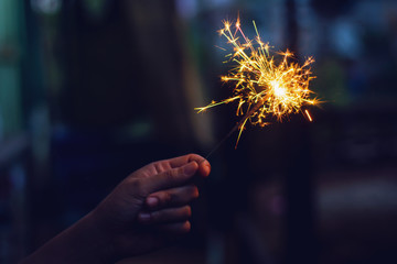 Christmas, New year sparkler in woman hands.