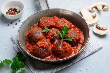 Meatballs in Tomato Sauce in a Frying Pan on Bright Backround