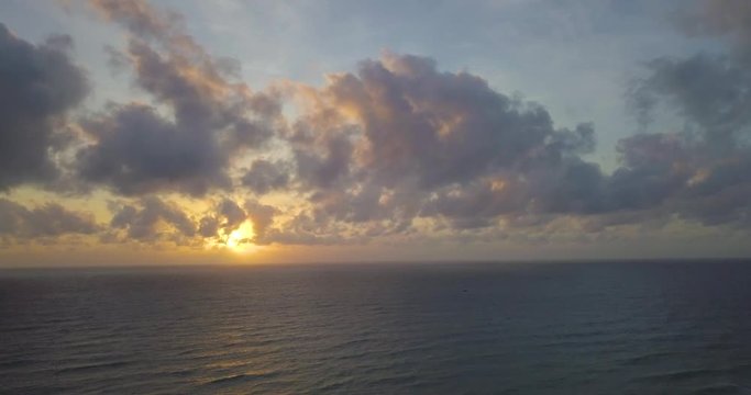 Aerial view beautiful tropical island beach sunrise, sunset from drone. Stock footage of landscape paradise tropical island beach with sunrise, sunset ocean water, wave, sea surface. Amazing nature