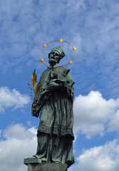 old statue in Prague against the blue sky