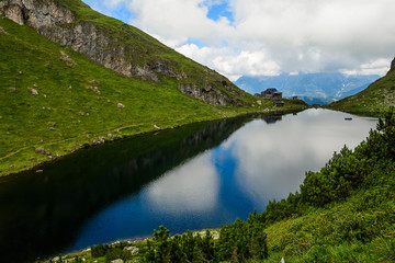 Naklejka na ściany i meble Beautiful landscape with Wildsee Lake ( Wildseelodersee ) and the Wildseeloderhaus, mountain refuge hut, above Fieberbrunn in the Kitzbuhel Alps, Tirol, Austria