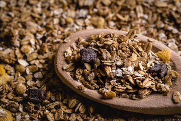 wooden spoon with oats, cereal and seeds.