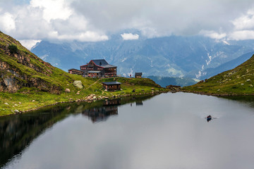 Fototapeta na wymiar Beautiful landscape with Wildsee Lake ( Wildseelodersee ) and the Wildseeloderhaus, mountain refuge hut, above Fieberbrunn in the Kitzbuhel Alps, Tirol, Austria