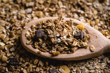 wooden spoon with oats, cereal and seeds.