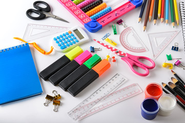 Set bright school supplies on white background.