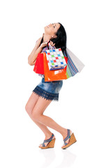 Young happy woman holding a shopping bags, isolated on white background