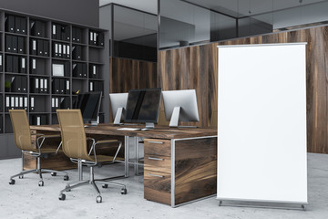 Gray office corner with vertical poster