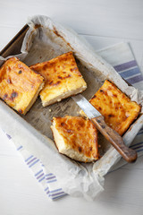 A piece of cottage cheese casserole with sour cream