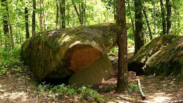 stone village in Ukraine, big stones in the forest, The tract stone village, Zhytomyr region village of Rudnya- Zamyslovichskaya, boulders covered with moss in a park