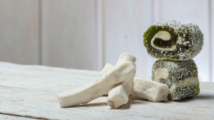 Rose turkish delight Rahat Lucum, candy on a white wooden background