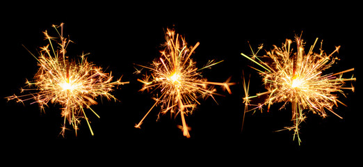 Set of Christmas sparkler burning isolated on black background.