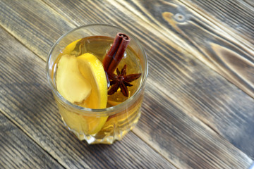 Ginger drink with lemon and spices Ginger tea on wooden table Copy space