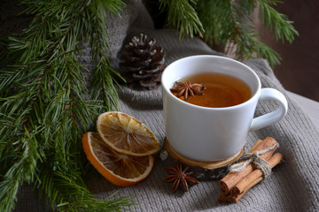 Obraz na płótnie Canvas Cup of lemon tea cookies cinnamon fir branch Winter holidays concept Cozy home