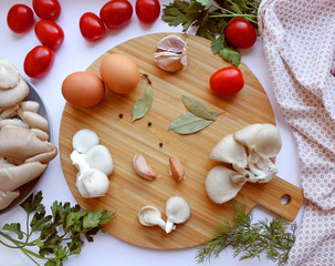 Fototapeta na wymiar board with eggs, mushrooms, greens and pepper