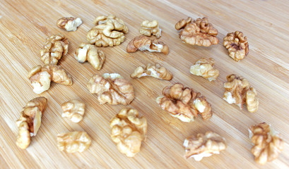 Fototapeta na wymiar walnut kernels in the shape of a rectangle on a wooden board