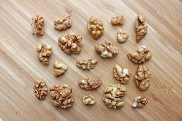 Fototapeta na wymiar walnut kernels in the shape of a rectangle on a wooden kitchen board