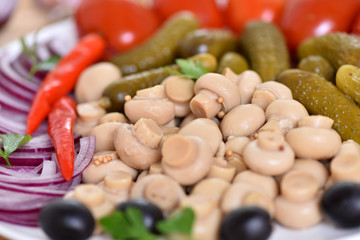 Pickles in assortment on a plate. Restaurant dish.