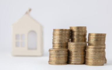 Mini house on stack of coins. Concept of Investment property. Housing on credit