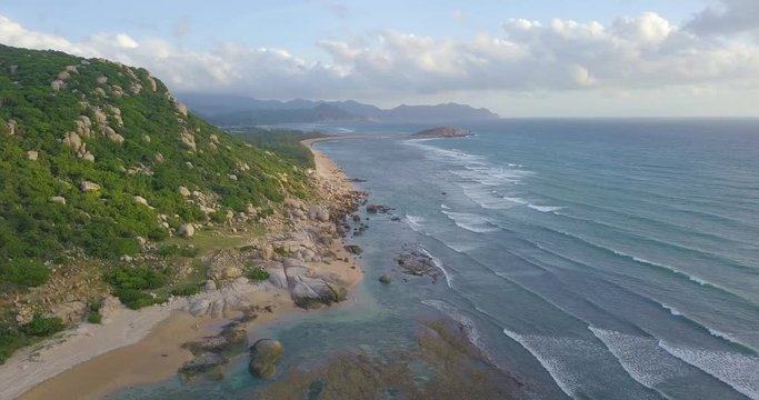 Aerial view of beautiful tropical island beach from drone. Stock footage of landscape of paradise tropical island beach with blue color ocean water, wave, sea surface. Top view and amazing nature 