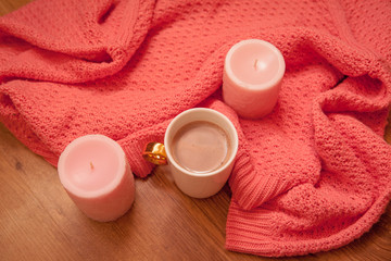 Fototapeta na wymiar Tasty coffee or cocoa on a wooden background and pink tablecloth.