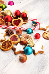 Fototapeta na wymiar Decoration with christmas cookies. Typical cinnamon stars with fruits and nuts