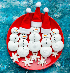 Funny meringue snowman food art idea for kids New Year and Christmas background