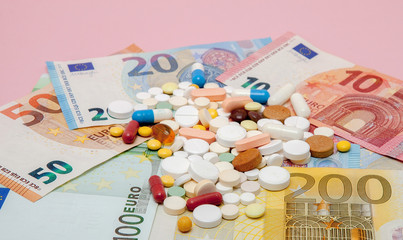 Money and pills. Pills of different colors on money. medicine concept. Euro cash