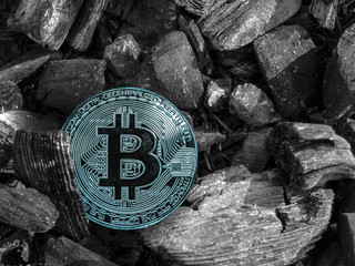 cryptocurrency BTC coin lies on coal. Mining and Energy for mining.