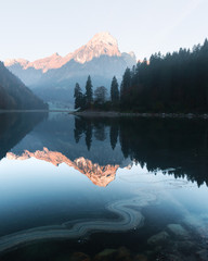 Peaceful autumn view on Obersee lake in Swiss Alps. Clear sky and mountains reflections in clear water. Nafels village, Switzerland. Landscape photography