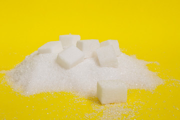 granulated and sugar cubes isolated on yellow background	