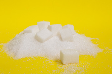 granulated and sugar cubes isolated on yellow background	