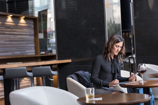 Businesswoman using digital tablet in hotel