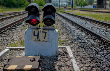 Traffic light shows red signal on railway. Red light. Railway tracks with red light semaphore