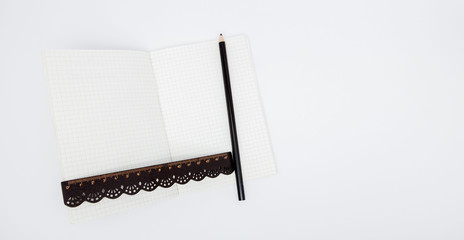 Pencil And Ruler On Notebook. Pencil and ruler on notebook with copy space on white background....