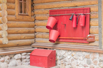 wooden shield with fire fighting tools on the wall of the house, close up