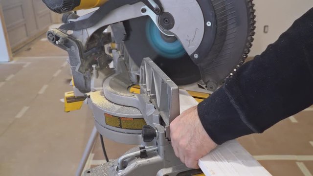 Contractor Using Circular Saw Cutting New Crown Moulding for Renovation.