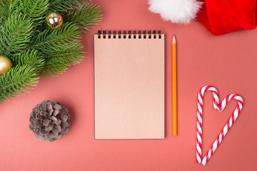 Blank notebook list, candy cane and fir tree. Top view with copy space. New year concept. Christmas concept. Winter concept.