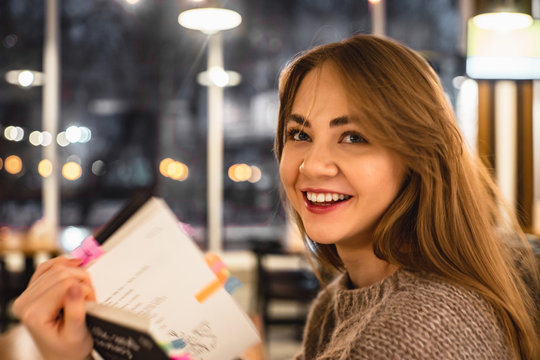 smiling young woman with book