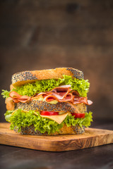 Sandwich with lettuce, sausage and tomatoes