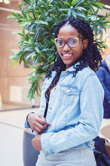 Young dark-skinned woman dressed in casual clothes in the mall