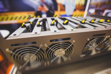 Close-up view of equipment for bitcoin cryptocurrency mining farm, electronic devices with fans,...