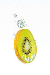 Sliced kiwi fruit splashing isolated on white background