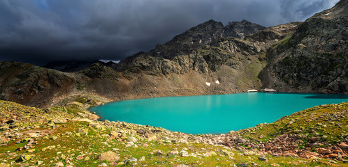 Fototapeta na wymiar Sophia lake in the mountains of Arkhyz. The beautiful summer panorama landscape with mountain and lake with blue water.