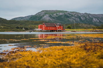 Northern Norway, Lapland, Red wood house at a fjord