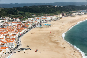 Fototapeta na wymiar Nazare is one of the most popular seaside resorts in Portugal, considered by some to be among the best beaches in Portugal.