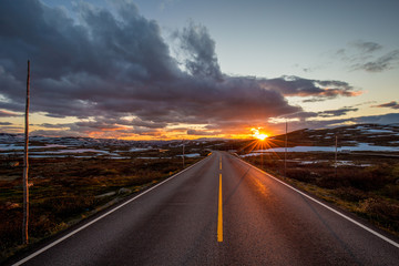 Sunset over lonely road in highlands in Norway