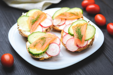 small sandwiches with salmon on vegetables