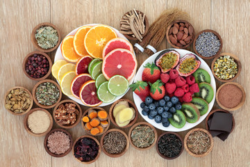 Stress and anxiety relieving health foods, herbs, spices and supplement powders that also help relaxation and reduce chronic fatigue and depression. Top view on oak wood table. - obrazy, fototapety, plakaty