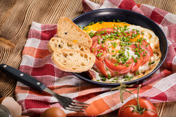 Homemade breakfast fried egg with tomato.